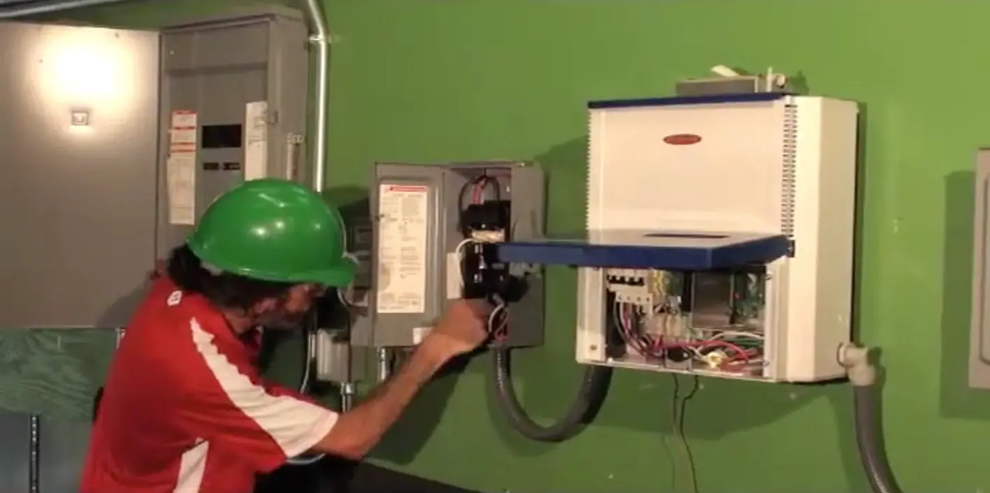 Ensuring System Compatibility On-Site Modern solar installation site with technician checking connections
