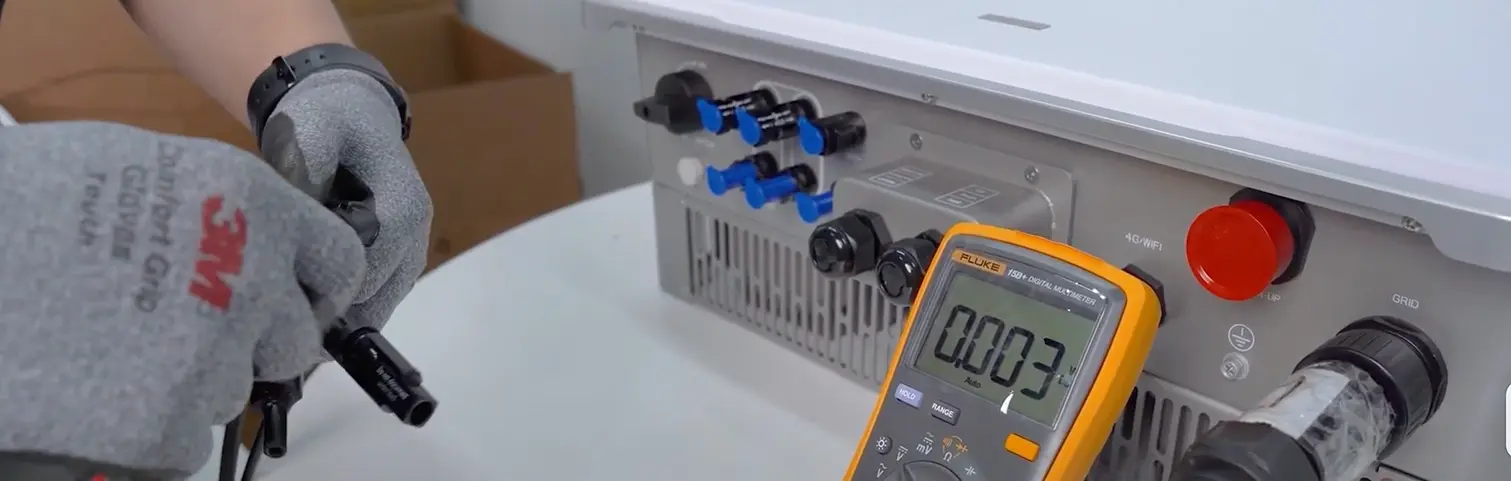 Troubleshooting Common Inverter Faults A technician troubleshooting an inverter with a multimeter
