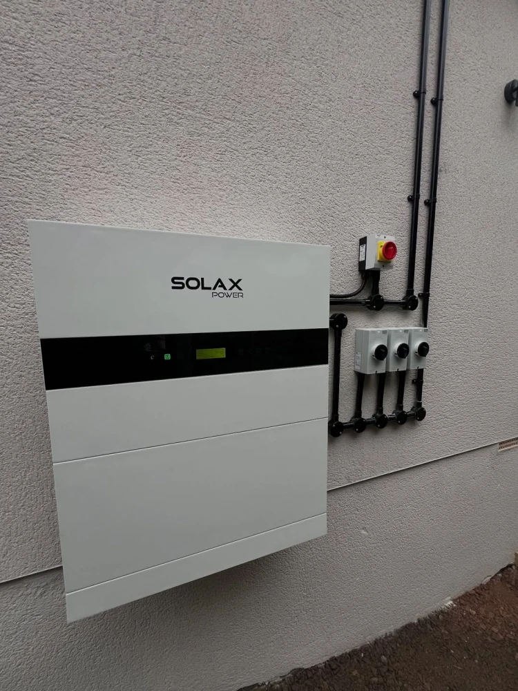 A compact, wall-mounted SolaX X1-IES system in a home utility area